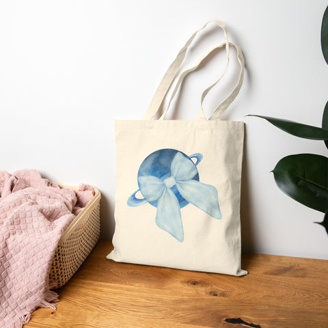 Blue Saturn Wrapped In Blue Bow Cotton Canvas Tote Bag